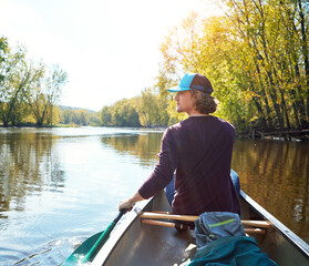 Man, canoeing and lake rowing in woods for morning adventure for exercise, exploring or island....