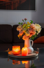 summer bouquet in home interior with burning candles