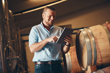 Business, man and proud with tablet in brewery as manager with smile on product, process and...