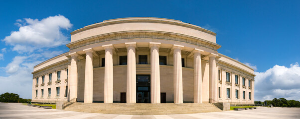 building in classical Greek style with columns against a blue sky