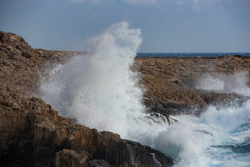 Windy sea waves crashing with power on the rocky coastline. Nature power wind stormy day
