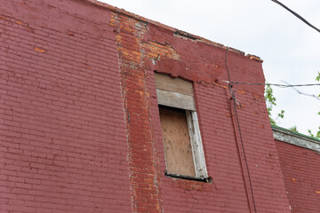 old building side and boarded up window