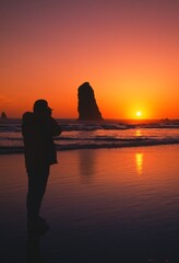 Silhouette Of Person Viewing Sunset, Rock Formation, Cannon Beach.