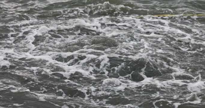 Mud and clay bursting up in water after dredging