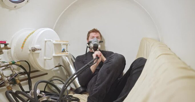Military man in hyperbaric chamber using BIBS mask closeup