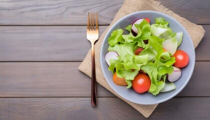 Fresh salad on a wooden background top view, concept of healthy food and veggie 