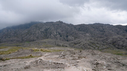 View of the empty hiking path across the rocky mountains. Beautiful rock texture and pattern.