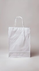 Empty white shopping bag on a plain background, ideal for custom logos or designs.