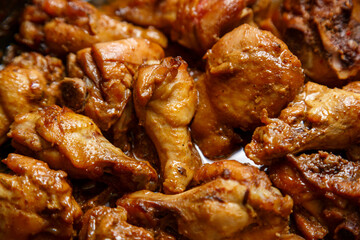 chicken breast pieces in a frying pan stewed in sauce