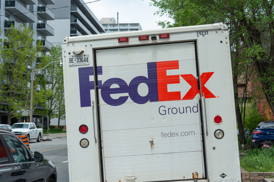 back of a FedEx Ground delivery truck stopped on a street in Toronto, Canada