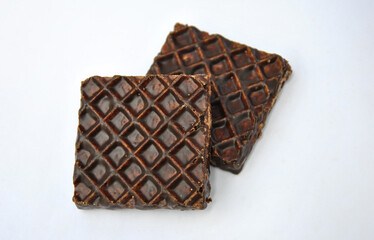 square wafers in chocolate on a white background
