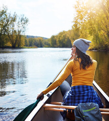 Woman, back and canoeing for fitness on water in nature, wellness hobby and single blade paddle for rowing. Vacation, relax and explore exercise on travel for summer holiday, kayak boat and river