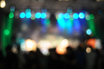 Defocused entertainment show lighting. Out of focus concert stage with bright spotlights with bokeh effect. Green light effect, Beautiful bokeh background