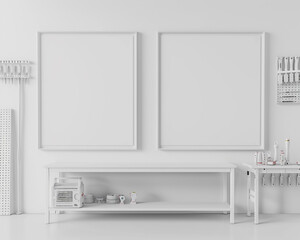 Contemporary chic white workshop area with two blank frames on a pure white wall, a white workbench, and white tool racks.