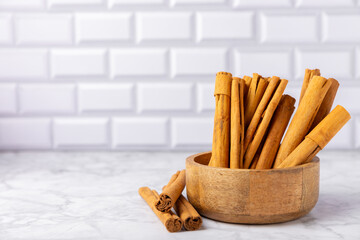 Ceylon cinnamon.Cinnamon sticks on a textured wooden background. Cinnamon roll and powder. Spicy spice for baking, desserts and drinks. Fragrant ground cinnamon. Close-up. Place for text. copy space