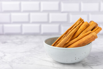 Ceylon cinnamon.Cinnamon sticks on a textured wooden background. Cinnamon roll and powder. Spicy spice for baking, desserts and drinks. Fragrant ground cinnamon. Close-up. Place for text. copy space