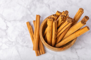 Ceylon cinnamon.Cinnamon sticks on a textured wooden background. Cinnamon roll and powder. Spicy spice for baking, desserts and drinks. Fragrant ground cinnamon. Close-up. Place for text. copy space