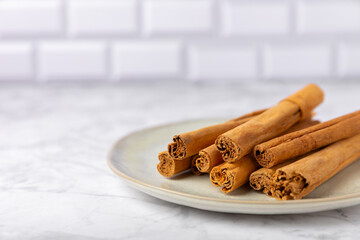 Ceylon cinnamon.Cinnamon sticks on a textured wooden background. Cinnamon roll and powder. Spicy spice for baking, desserts and drinks. Fragrant ground cinnamon. Close-up. Place for text. copy space