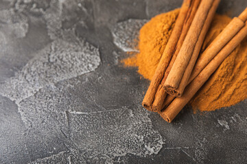 Ceylon cinnamon.Cinnamon sticks on a textured wooden background. Cinnamon roll and powder. Spicy spice for baking, desserts and drinks. Fragrant ground cinnamon. Close-up. Place for text. copy space