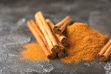 Ceylon cinnamon.Cinnamon sticks on a textured wooden background. Cinnamon roll and powder. Spicy spice for baking, desserts and drinks. Fragrant ground cinnamon. Close-up. Place for text. copy space