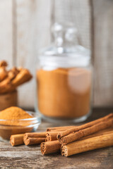 Ceylon cinnamon.Cinnamon sticks on a textured wooden background. Cinnamon roll and powder. Spicy spice for baking, desserts and drinks. Fragrant ground cinnamon. Close-up. Place for text. copy space