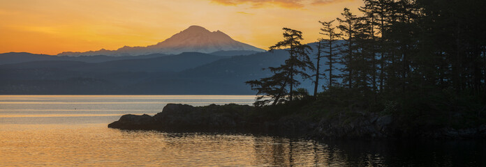 Abner Point on Lummi Island with Mt. Baker in the background. Seen from the Aiston Preserve with Smugglers Cove in the foreground and Bellingham Bay and the city of Bellingham in the distance.