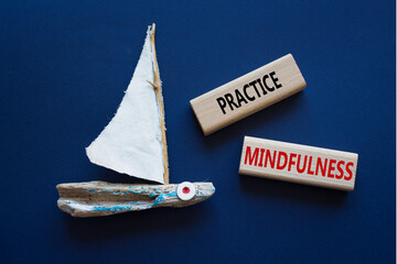 Practice Mindfulness symbol. Concept words Practice Mindfulness on wooden blocks. Beautiful deep...