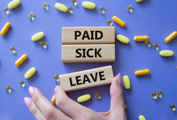 Paid Sick Leave symbol. Concept words Paid Sick Leave on wooden blocks. Beautiful purple background...