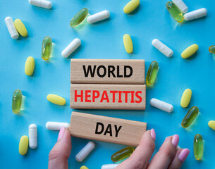 World Hepatitis Day symbol. Concept words World Hepatitis Day on wooden blocks. Beautiful blue...