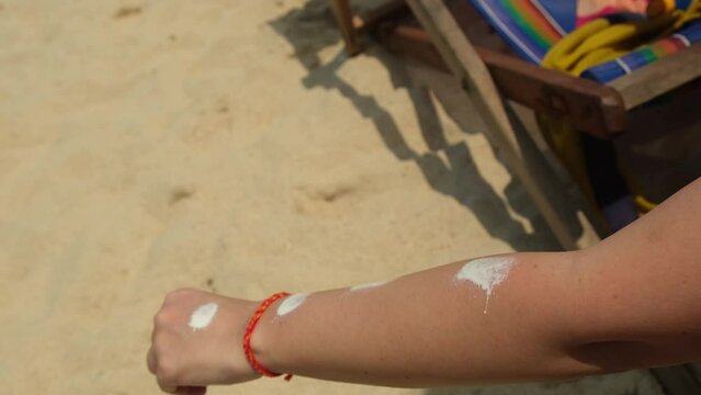 girl applying sunscreen to her hand	
