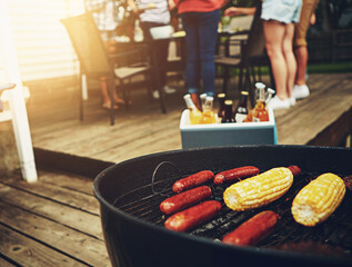 Outside, food and barbecue on weekend with grill for corn, sausage and cooking on porch or backyard. Drinks, friends and celebration party with reunion, meal and summer in America with family.