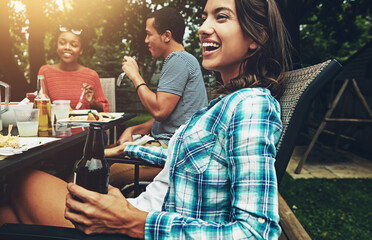 Woman, beer and happy in backyard with bbq for social event, party or celebration with laughing in...