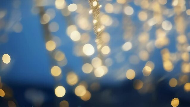 Twinkling golden lights bokeh animation seamless loop video background for festive projects. Golden string lights bokeh animation. Celebration and Nightlife Concept