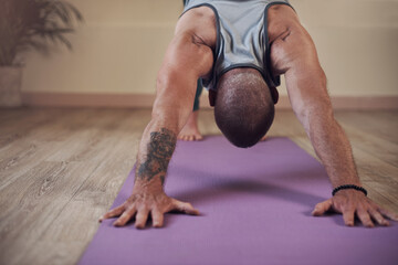 Man, yoga and downward dog in home for health, wellness and body flexibility for practice routine....
