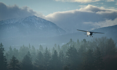 Small plane landing in the mountains in Comox, BC.