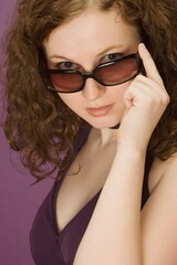 Brunette Woman Peering Over Sunglasses