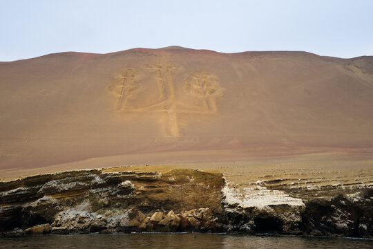 The Paracas Candelabra, or Candelabra of the Andes, a well-known prehistoric geoglyph, Paracas Peninsula, Pisco Bay in Peru, from the sea