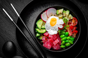 Tuna Poke bowl composition on black background. The Art of Japanese Cuisine. Food photography for menu and sushi bar decoration