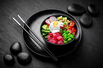 Tuna Poke bowl composition on black background. The Art of Japanese Cuisine. Food photography for menu and sushi bar decoration