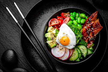 Smoked Eel Poke bowl composition on black background. The Art of Japanese Cuisine. Food photography for menu and sushi bar decoration