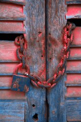 Padlock And Chain On Wooden Door