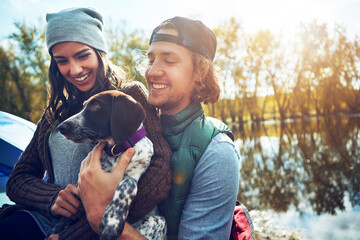 Couple, smile and hug dog by camping for adventure by love of freedom in nature lake, sunshine and...