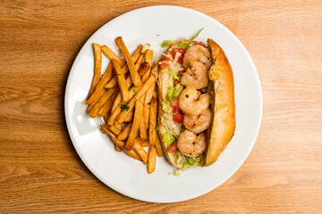 Shrimp po boy sandwich with French fries