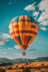 Hot air balloon flying over mountains landscape. Summer travel and adventure concept. Beautiful landscape. Design for banner, wallpaper, poster 