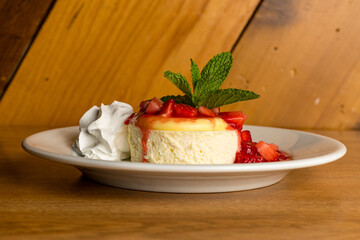 Individual serving of cheesecake with strawberries and whipped cream
