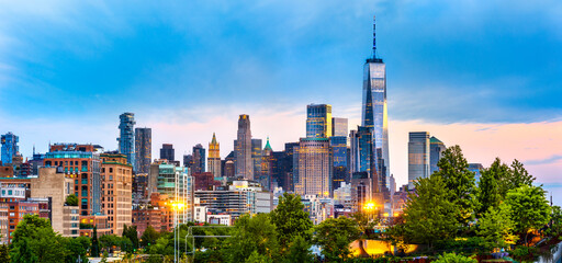 Panoramic view of Lower Manhattan skyline at at dusk, behind the Little Island public park.