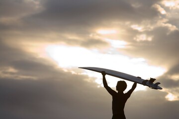 A Surfer On Muriwai Beach, New Zealand