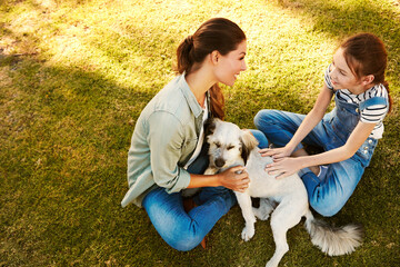 Mom, girl and dog in park to relax with bonding, love and above on holiday with care for animal....