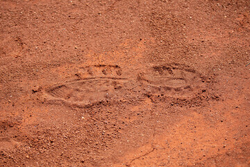 Shoe footprint in the red earth