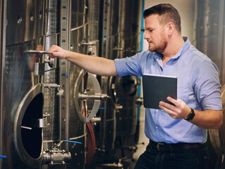 Brewery, man and tablet in factory for alcohol fermentation, craft beer and wine introspection with...